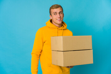 Young caucasian man doing moving over isolated background