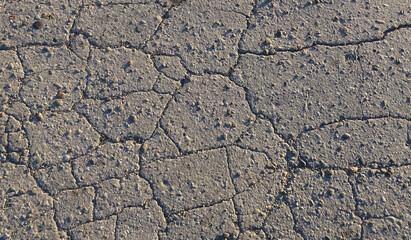 Texture of gray cracked asphalt. Road with cracks