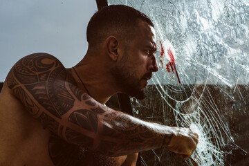 Sexy bloody man. Guy after crash. Fist fight. Brutal blood hunk with tattooed body. Muscular body...