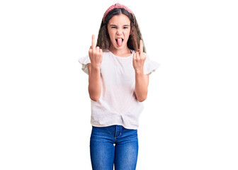 Obraz na płótnie Canvas Cute hispanic child girl wearing casual white tshirt showing middle finger doing fuck you bad expression, provocation and rude attitude. screaming excited