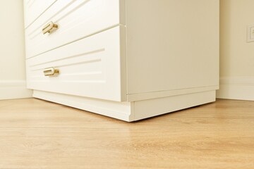 White wooden chest of drawers with vintage bronze handles