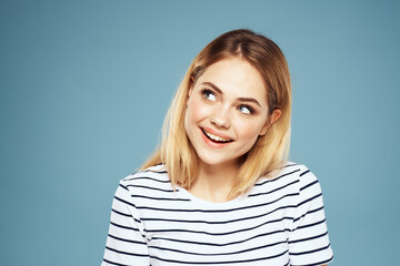 Blonde girl in striped t-shirt lifestyle blue background fun