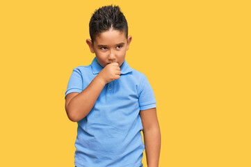Little boy hispanic kid wearing casual clothes feeling unwell and coughing as symptom for cold or bronchitis. health care concept.