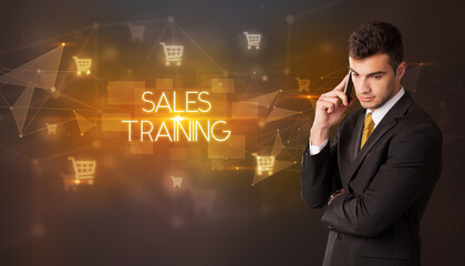 Businessman with shopping cart icons and SALES TRAINING inscription, online shopping concept