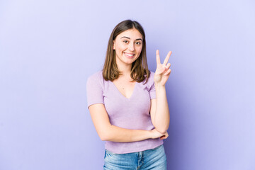 Young caucasian woman showing number two with fingers.