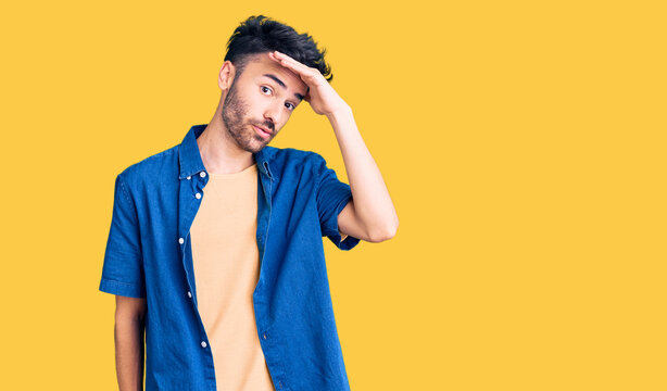 Young hispanic man wearing casual clothes surprised with hand on head for mistake, remember error. forgot, bad memory concept.