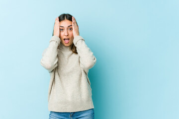 Young caucasian woman having fun covering half of face with palm.