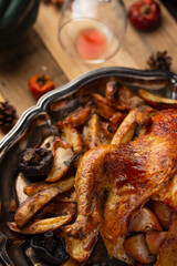 Close-up view of round dish with baked turkey and potato on wooden background. Festive dinner. Thanksgiving concept. Traditional recipe.