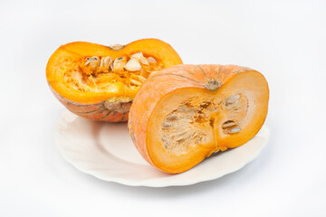 two halves of pumpkin lie on a terrace on a white background