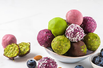 Raw vegan homemade dessert. energy balls and bites in colorful chocolate glaze . Healthy vegan snacks