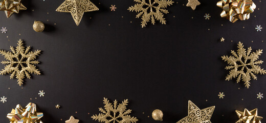 Top view of golden snowflake, stars and Christmas ball on black background with copy space for text. Black Friday Sale, Banner, poster composition. - Powered by Adobe