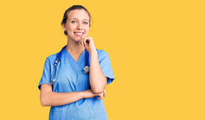 Young beautiful blonde woman wearing doctor uniform and stethoscope looking confident at the camera...