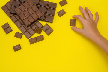 baby's Pen reaches for a slice of milk chocolate