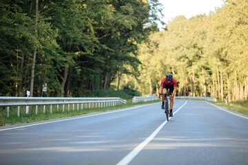 Man riding bike with high speed on asphalt road
