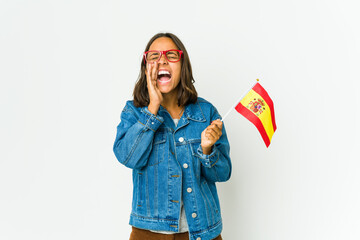 Young spanish woman holding a flag isolated on white background