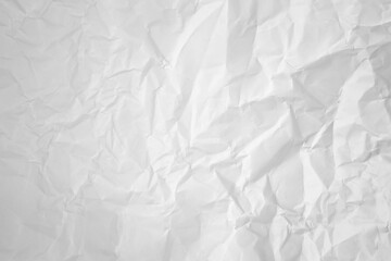 white and gray crumpled paper texture background. crush paper so that it becomes creased and wrinkled.