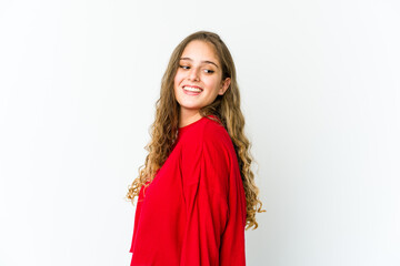 Young caucasian woman looks aside smiling, cheerful and pleasant.