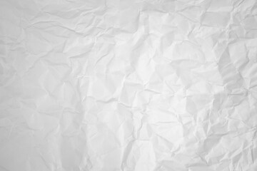 white and gray crumpled paper texture background. crush paper so that it becomes creased and wrinkled.