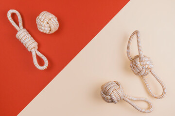 Cotton ecological dog's toys and leisure equipment for pets on beige background. Flat lay. Training...