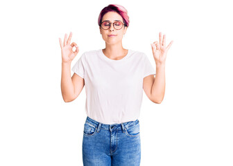 Young beautiful woman with pink hair wearing casual clothes and glasses relax and smiling with eyes closed doing meditation gesture with fingers. yoga concept.