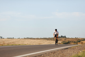 Obraz premium Strong cyclist having long distance racing on asphalt road