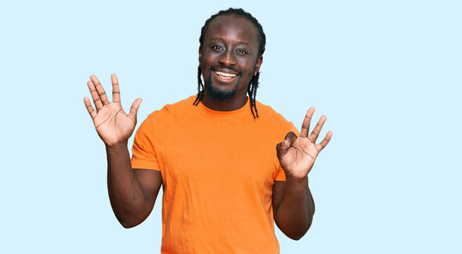Handsome young african american man wearing casual clothes showing and pointing up with fingers number eight while smiling confident and happy.