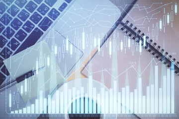 Stock market graph and top view computer on the table background. Double exposure. Concept of financial education.