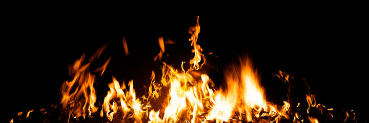 Burning red hot sparks rise from large fire in the night. Fire flames sparks background. Abstract...
