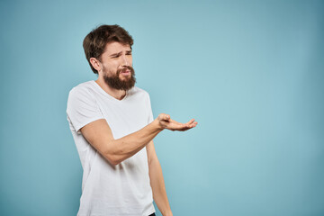 Man in white t-shirt emotions facial expression cropped view studio blue background lifestyle