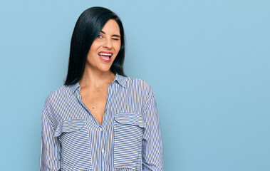 Young caucasian woman wearing casual clothes winking looking at the camera with sexy expression,...