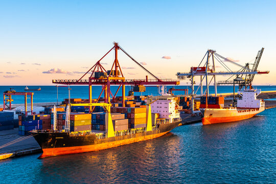 Barcelona, Spain - November 06 2018: Emona Cargo Ship and Renate P Bulk Container Vessel docked at Port of Barcelona. Cranes load/ unload bulk freighter merchant containers at shipping terminal dock.