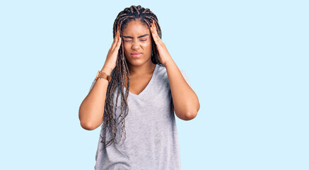 Young african american woman with braids wearing casual clothes suffering from headache desperate and stressed because pain and migraine. hands on head.