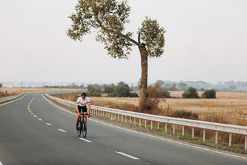 Male athlete using bike for sport activity on road