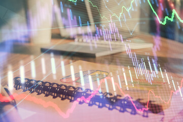 Double exposure of financial graph drawings and desk with open notebook background. Concept of forex market