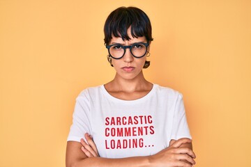 Fototapeta premium Beautiful brunettte woman wearing sarcastic comments loading t-shirt skeptic and nervous, disapproving expression on face with crossed arms. negative person.