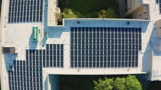 Aerial Drone Shot Flying Over a Large PV Solar Installation on Bayside HS Roof