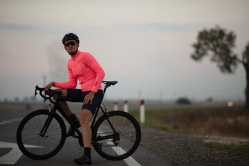Professional cyclist relaxing on fresh air after road racing