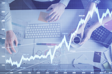 Double exposure of man and woman working together and financial chart hologram drawing. market analysis concept. Computer background. Top View.