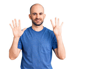 Young handsome man wearing casual t shirt showing and pointing up with fingers number nine while...