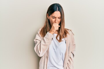 Brunette young woman wearing casual clothes feeling unwell and coughing as symptom for cold or bronchitis. health care concept.