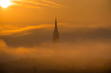 Fototapeta premium Cityscape of Graz with Church of the Sacred Heart of Jesus and historic buildings, in Graz, Styria region, Austria, at sunrise. Beautiful foggy morning over the city of Graz, in autumn