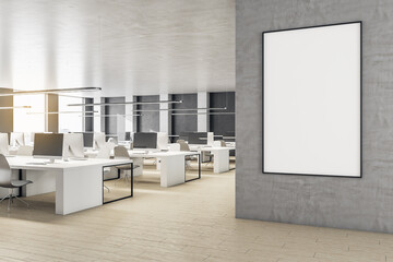 Modern workplace interior with computer and blank poster