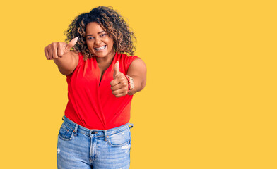 Young african american plus size woman wearing casual style with sleeveless shirt approving doing...