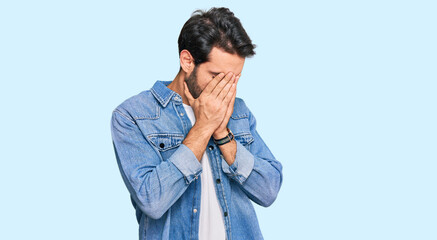 Young hispanic man wearing casual clothes with sad expression covering face with hands while...