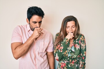 Beautiful young couple of boyfriend and girlfriend together feeling unwell and coughing as symptom for cold or bronchitis. health care concept.