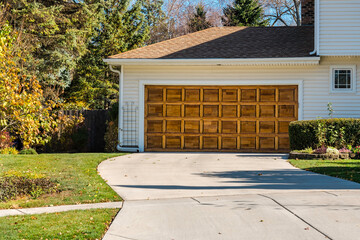 Traditional old wooden car garage door with driveway
