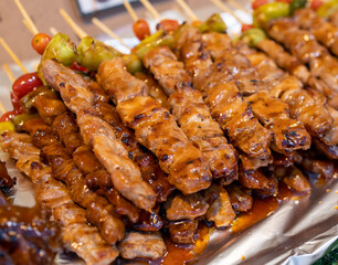 Grilled and marinated pork skewers with chili and tomato, Thai street food