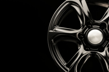 matte black alloy wheel, close-up front view. Powerful wheel for off-road vehicles, copyspace