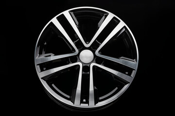 new shiny alloy wheel, color black with silver front. Dark background, front view