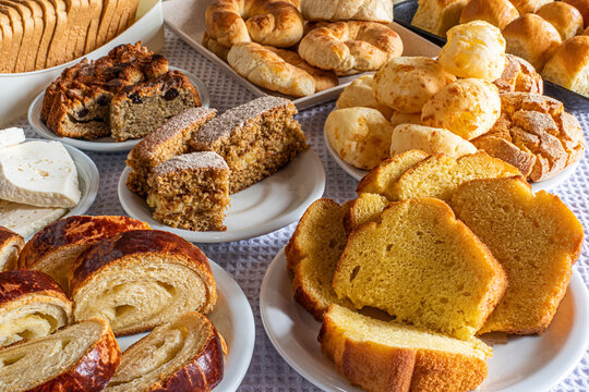Breakfast table in hotel, with sweets, cakes, cheese bread and bread. Brazilian Mineira food and cuisine.